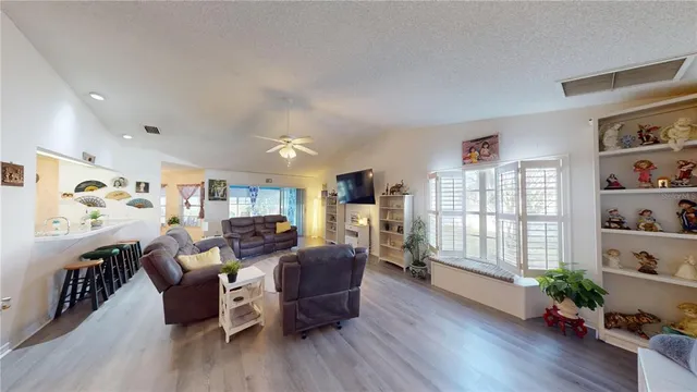 a living room with furniture fireplace and wooden floor
