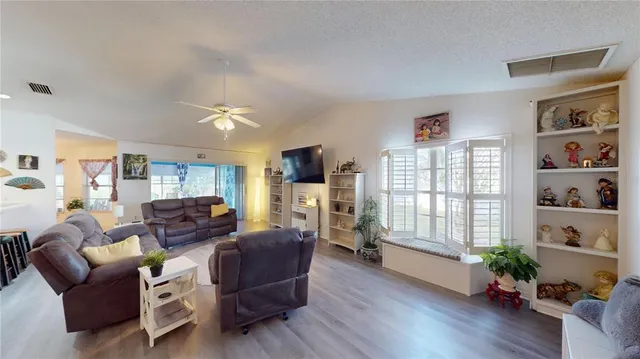 a living room with furniture fireplace and wooden floor