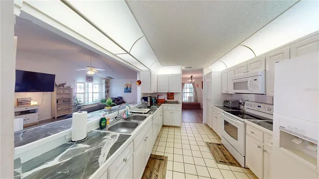 a large kitchen with lots of counter space and stainless steel appliances