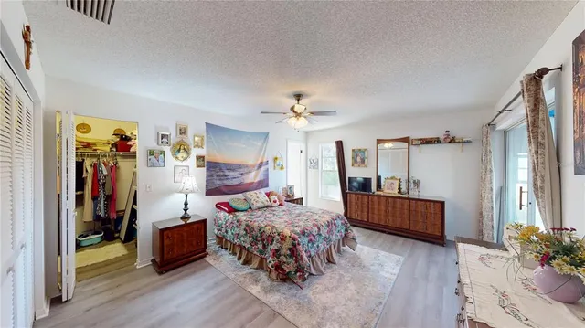 a bedroom with bed and a chandelier