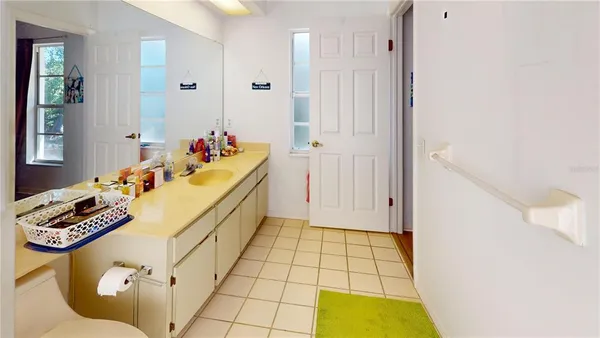 a bathroom with a sink mirror and vanity