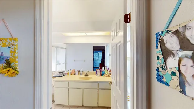 a bathroom with a sink mirror and vanity