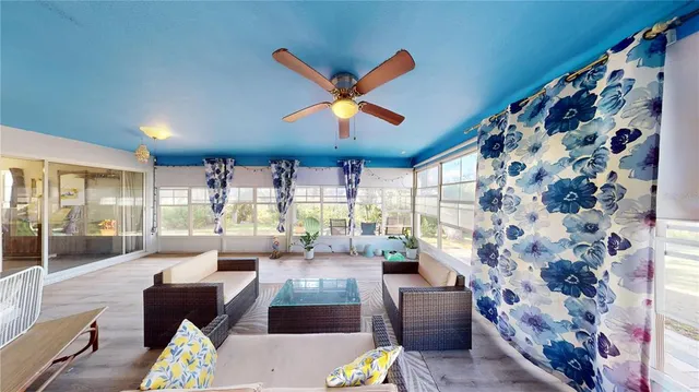 a living room with furniture and a large window with outer view