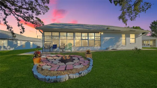 a view of a backyard with a garden and outdoor seating