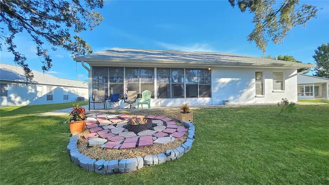 a view of a house with backyard outdoor seating area and furniture
