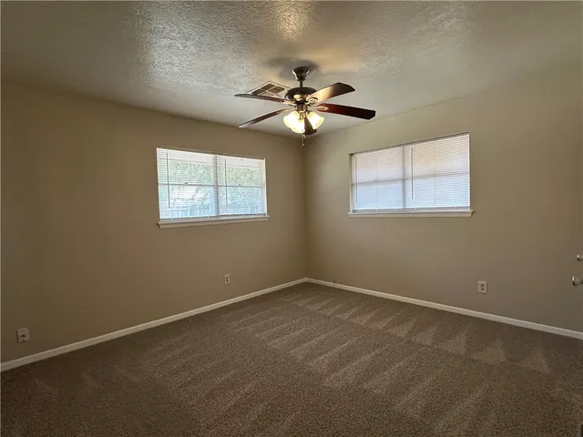 a view of room with a ceiling fan and window