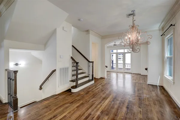a view of a room with wooden floor staircase and windows