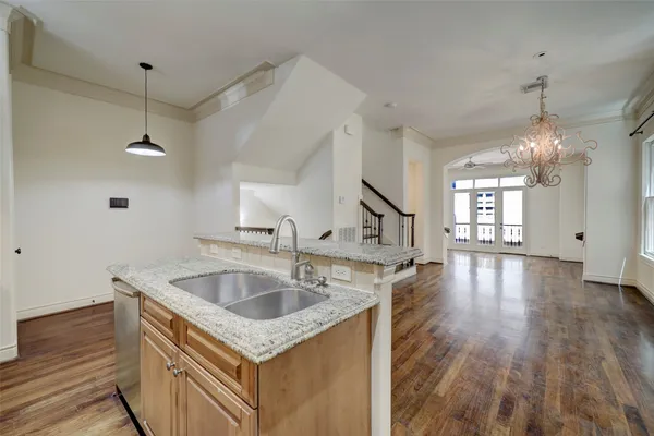 a kitchen that has a sink a window and cabinets