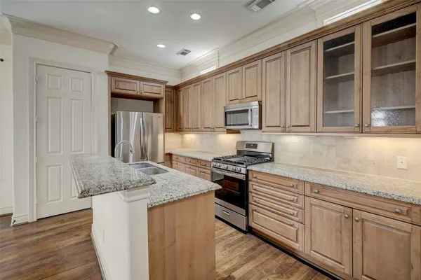 a kitchen with appliances cabinets and a counter top space