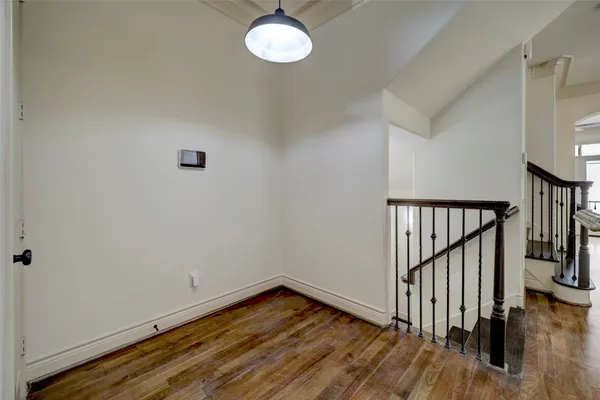 a view of a room with wooden floor and stairs