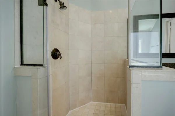 a bathroom with a shower and a sink