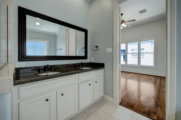 a bathroom with a double vanity sink and a mirror