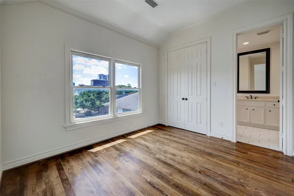 a view of a livingroom with wooden floor and a window