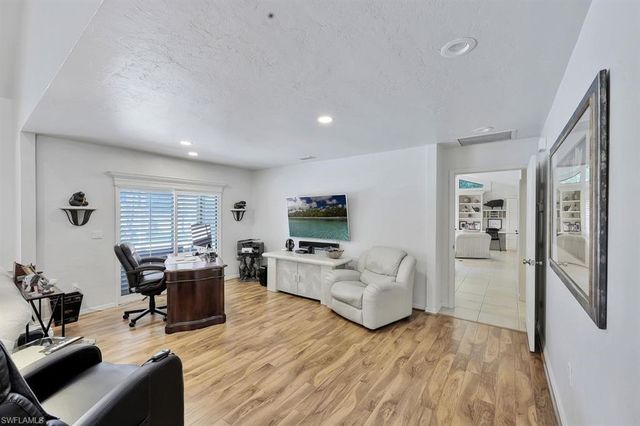 a living room with furniture wooden floor and flat screen tv