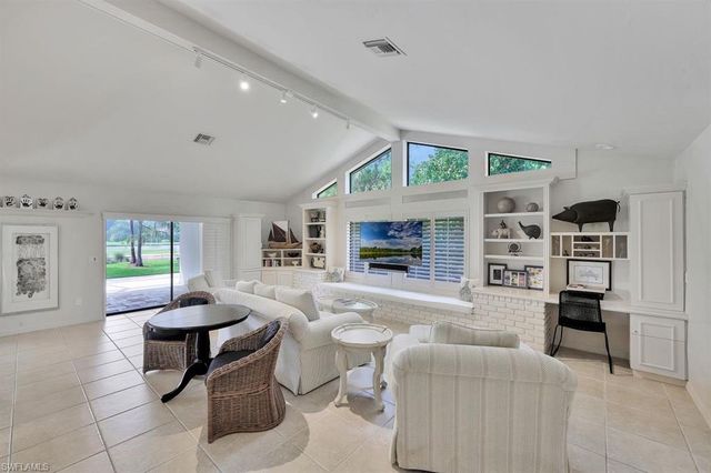a living room with fireplace furniture and a flat screen tv