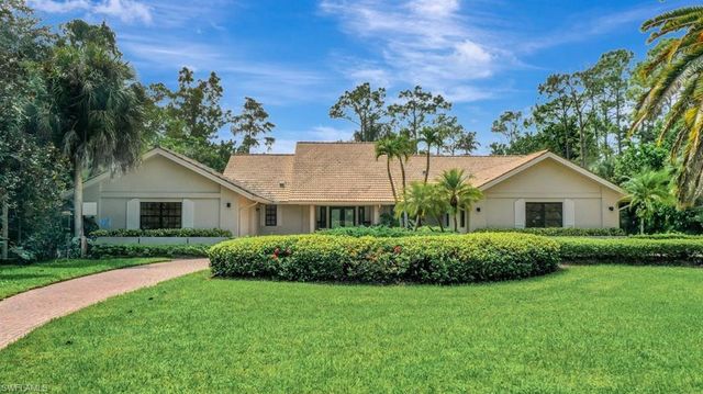 a front view of house with yard and green space