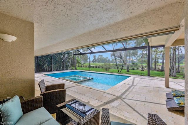 a view of a patio with a table and chairs