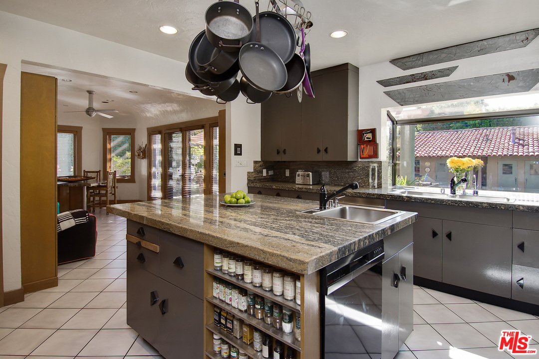 701 North Alpine Drive Beverly Hills, CA 90210 - Photo 11 of 22 a kitchen with stainless steel appliances granite countertop a sink a stove and a wooden cabinets
