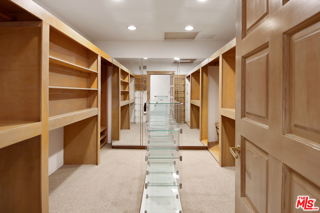 701 North Alpine Drive Beverly Hills, CA 90210 - Photo 14 of 22 a view of walk in closet with clothes and shoes