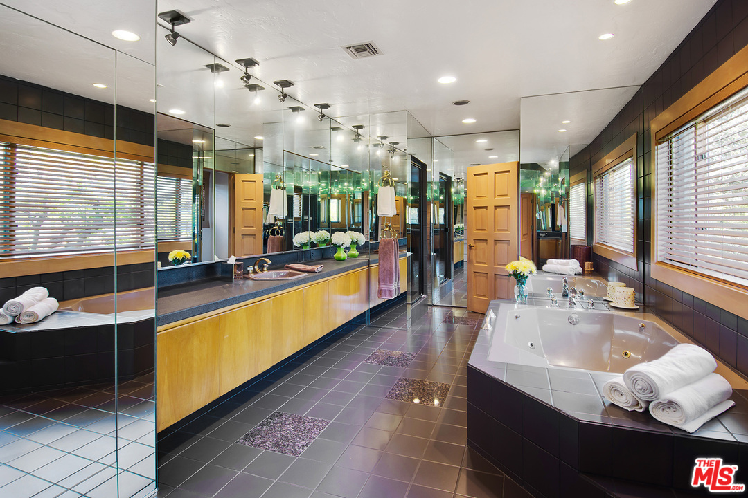 701 North Alpine Drive Beverly Hills, CA 90210 - Photo 15 of 22 a large kitchen with stainless steel appliances lots of counter space and breakfast area
