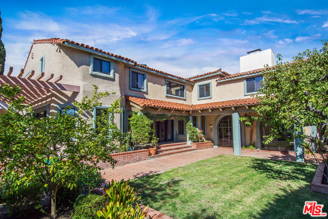 701 North Alpine Drive Beverly Hills, CA 90210 - Photo 17 of 22 a front view of a house with a yard