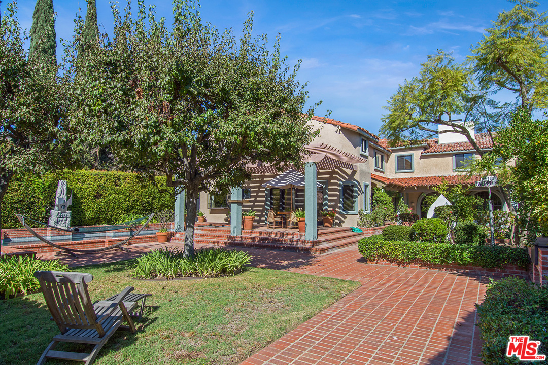 701 North Alpine Drive Beverly Hills, CA 90210 - Photo 18 of 22 a front view of a house with garden