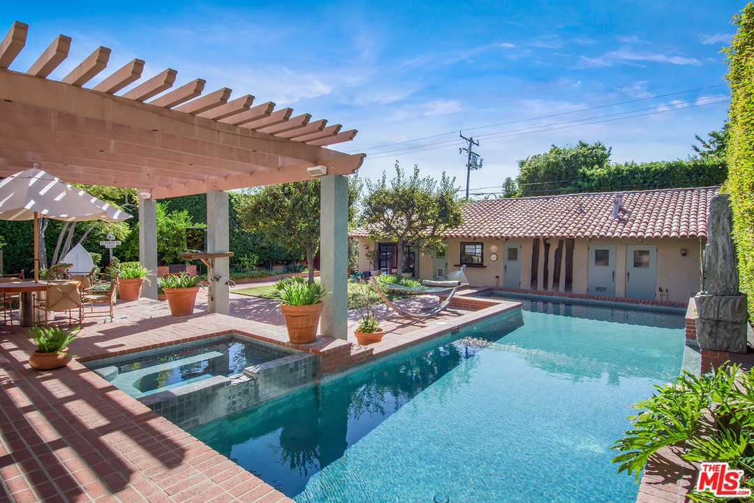 701 North Alpine Drive Beverly Hills, CA 90210 - Photo 19 of 22 a view of a house with backyard and sitting area