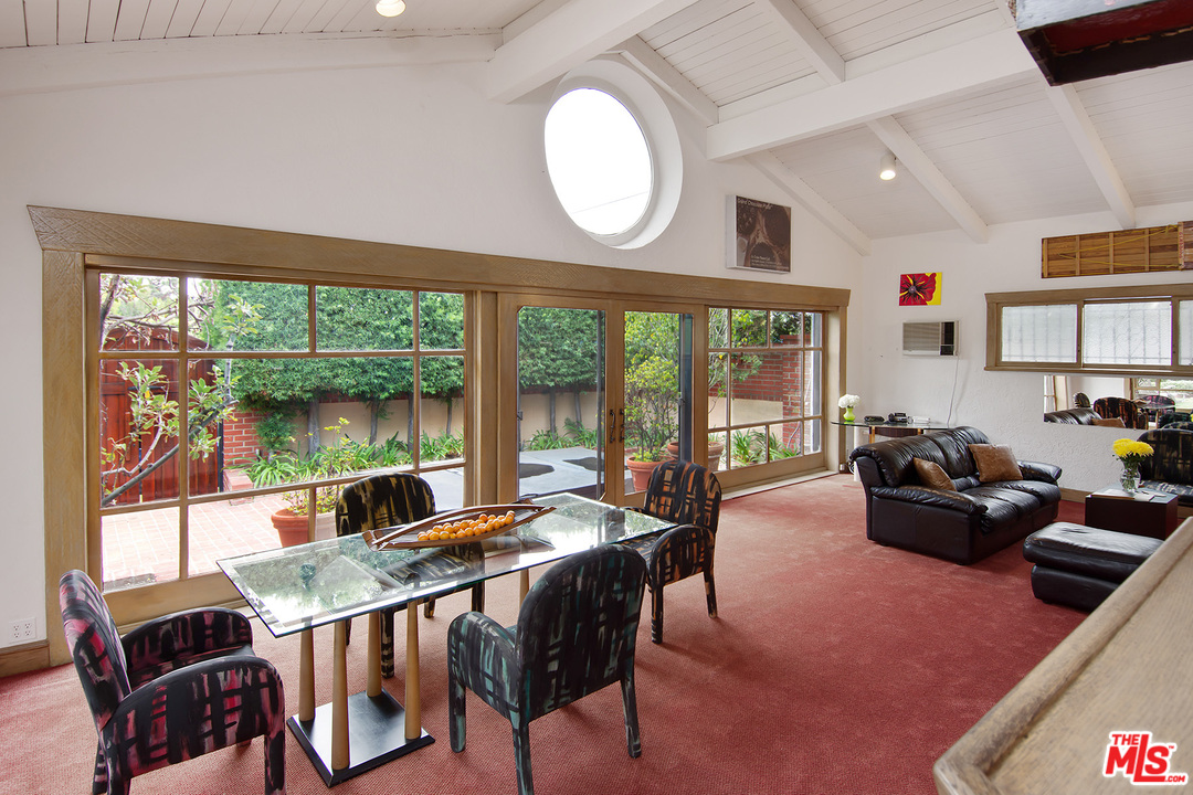 701 North Alpine Drive Beverly Hills, CA 90210 - Photo 21 of 22 a living room with furniture and a large window