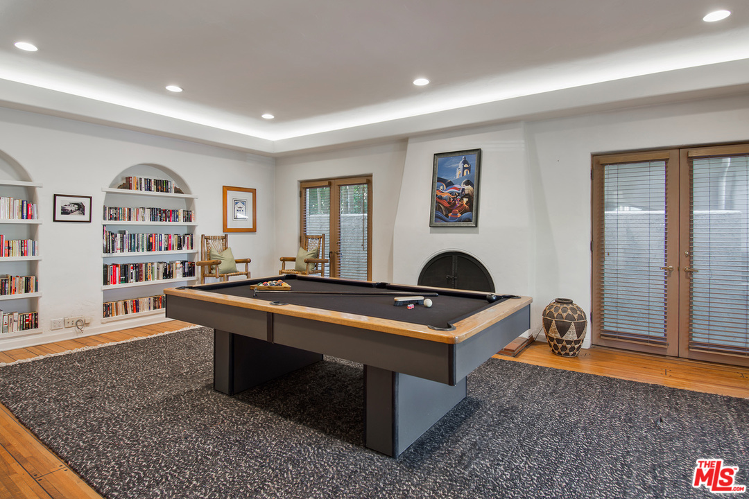 701 North Alpine Drive Beverly Hills, CA 90210 - Photo 4 of 22 a living room with furniture a rug and bookshelf
