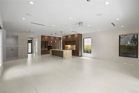 a view of kitchen with refrigerator and window