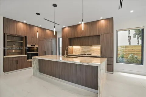a kitchen with stainless steel appliances granite countertop a stove and a refrigerator