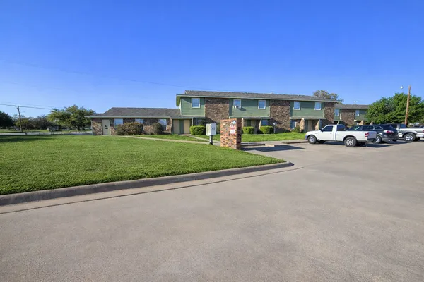 a view of a street with a car parked in front of it