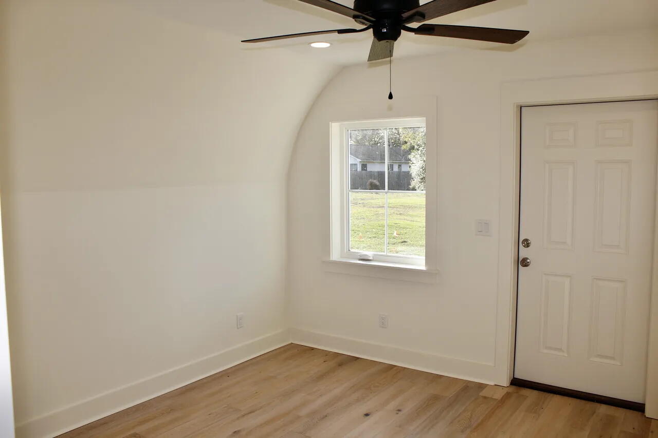 54 Davis Street DeFuniak Springs, FL 32435 - Photo 13 of 14 an empty room with wooden floor fan and windows