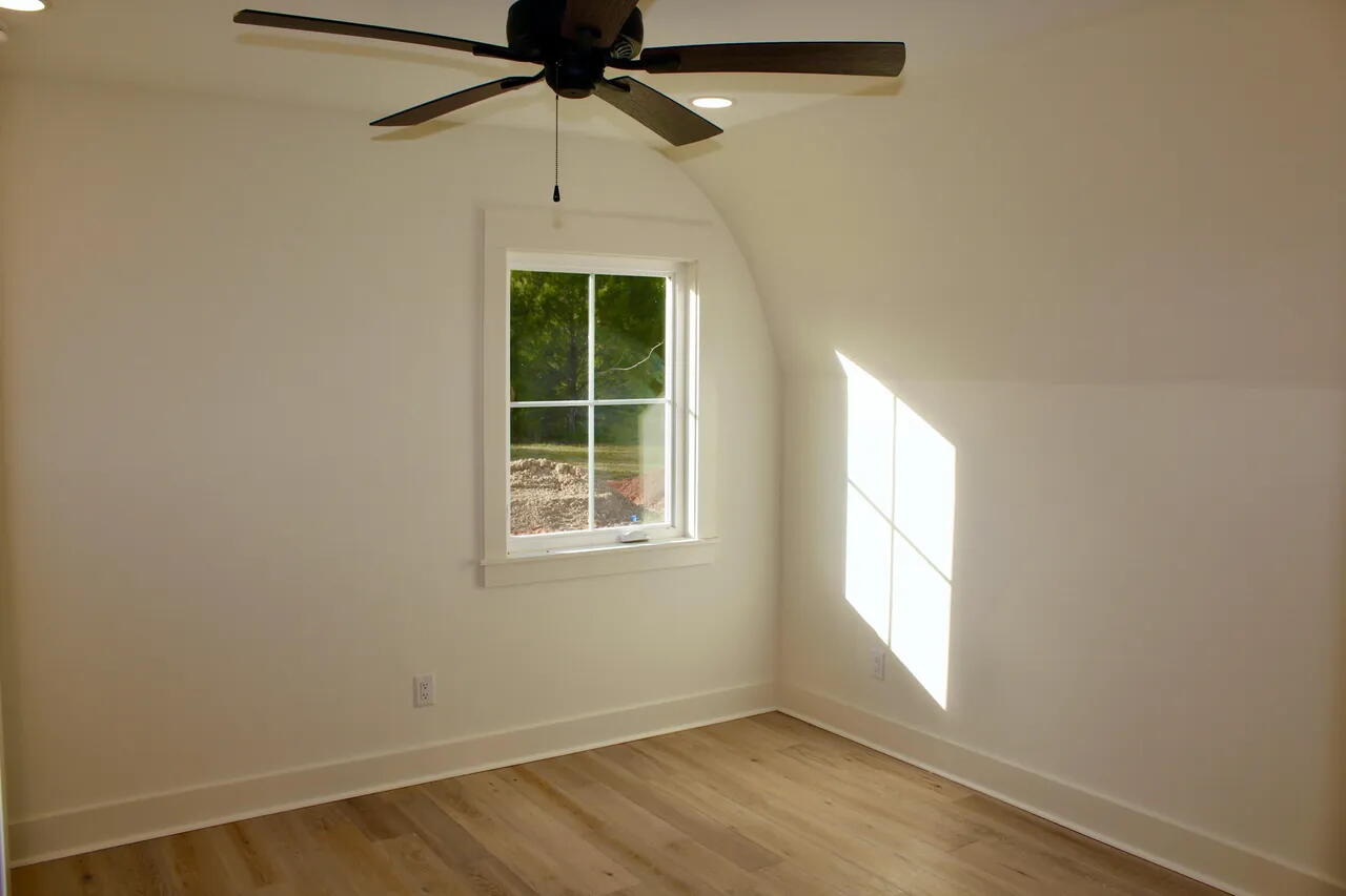 54 Davis Street DeFuniak Springs, FL 32435 - Photo 14 of 14 an empty room with windows and fan