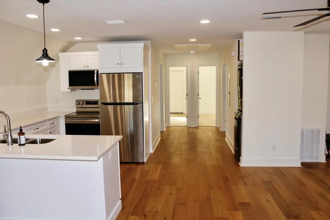 54 Davis Street DeFuniak Springs, FL 32435 - Photo 4 of 14 a kitchen with kitchen island white cabinets and stainless steel appliances