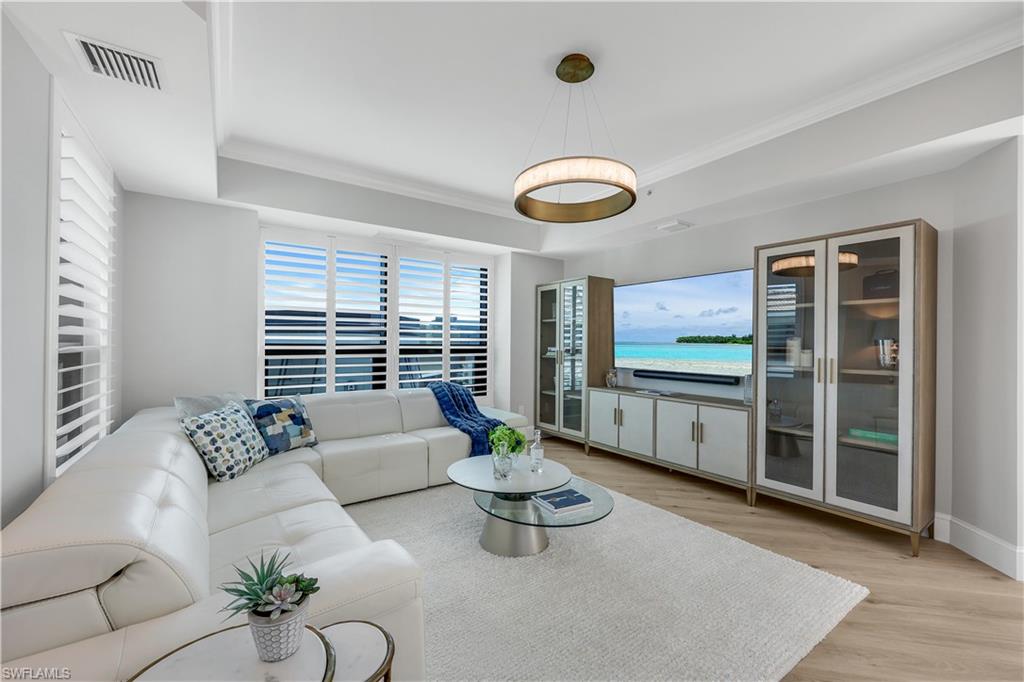 9115 Strada Place, Unit 5502 Naples, FL 34108 - Photo 13 of 48 Living area with ornamental molding and light wood finished floors