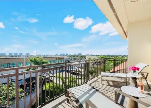 a view of a kitchen with stainless steel appliances granite countertop a stove a sink and a microwave