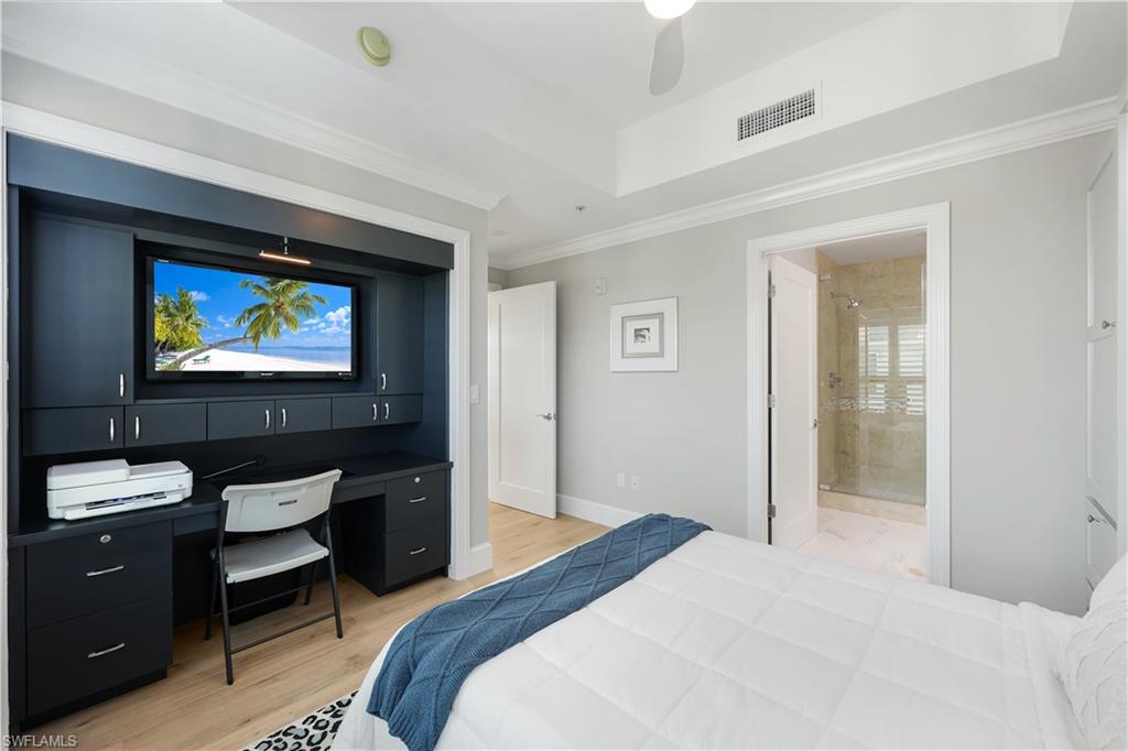 9115 Strada Place, Unit 5502 Naples, FL 34108 - Photo 24 of 48 Second Bedroom/ office featuring light wood-style flooring, a ceiling fan, a desk with built in cabinets and crown molding