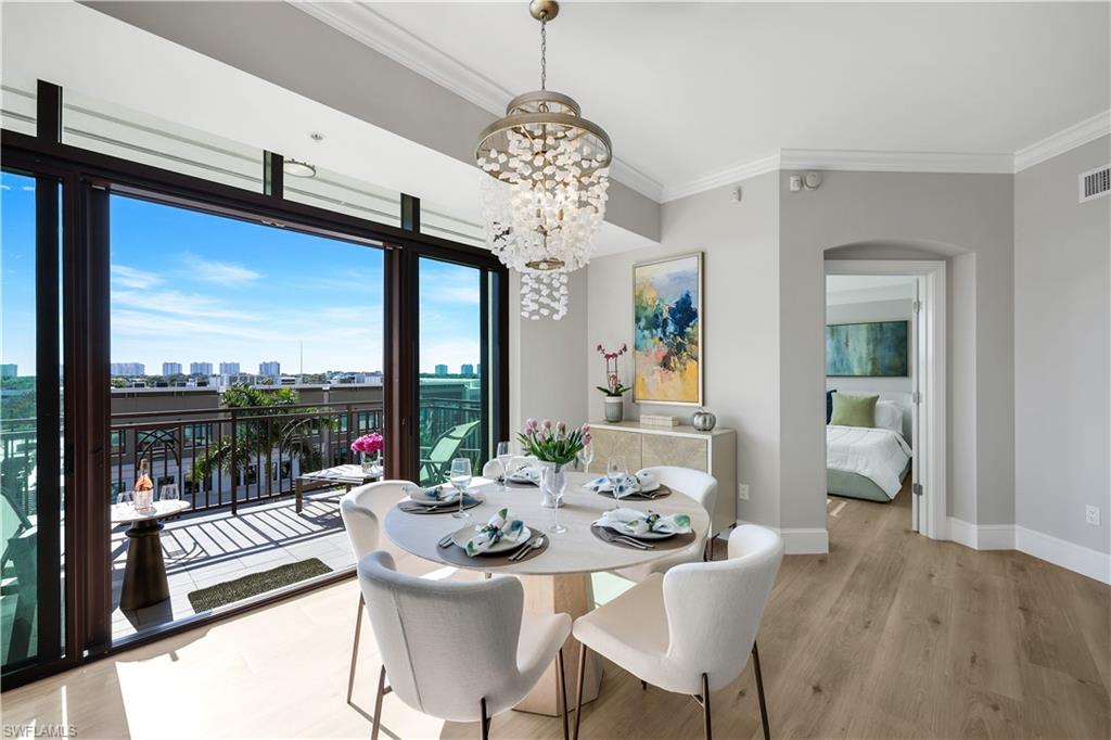 9115 Strada Place, Unit 5502 Naples, FL 34108 - Photo 5 of 48 Dining space featuring a city view and a Spectacular Chandelier
