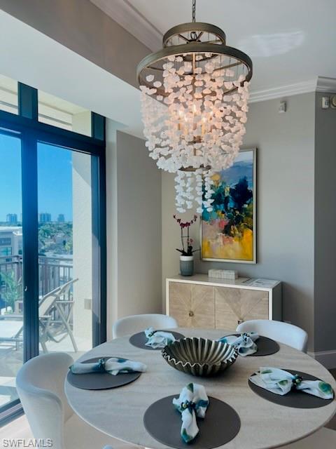 9115 Strada Place, Unit 5502 Naples, FL 34108 - Photo 6 of 48 Dining room featuring crown molding, a chandelier, and a view of city