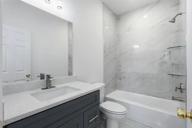 a bathroom with a sink a toilet and a bathtub