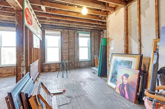 a view of a room with wooden floor and windows