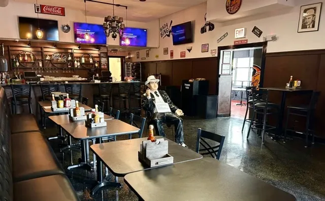 a room with stainless steel appliances kitchen island granite countertop a dining table and chairs with wooden floor