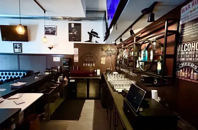 a kitchen with a stove a sink and a dining table