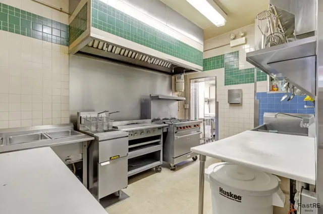 a kitchen that has a stove and a table