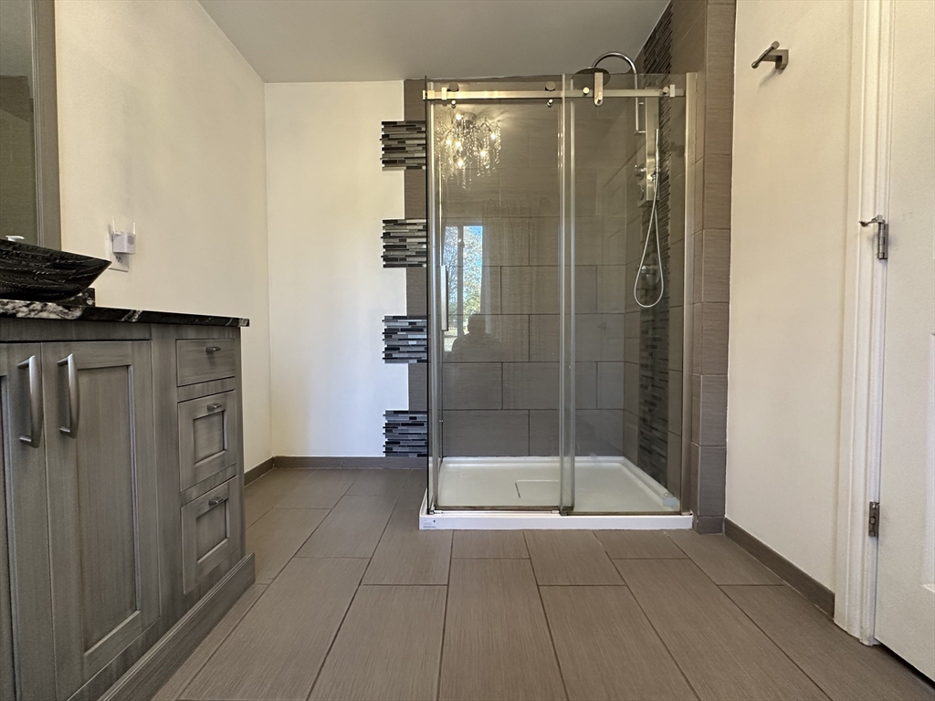 712 Cooper Street Agawam, MA 01001 - Photo 12 of 26 a bathroom with a shower and a sink