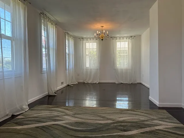 a view of a room with wooden floor and staircase