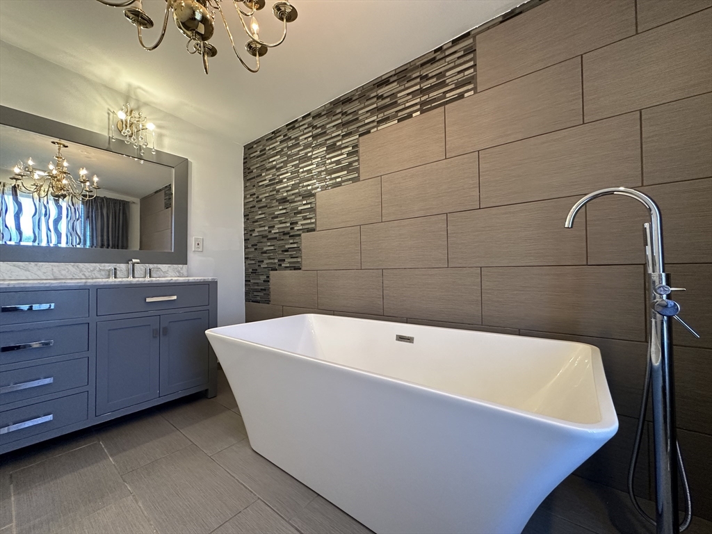 712 Cooper Street Agawam, MA 01001 - Photo 17 of 26 a bath tub sitting in a bathroom and a sink