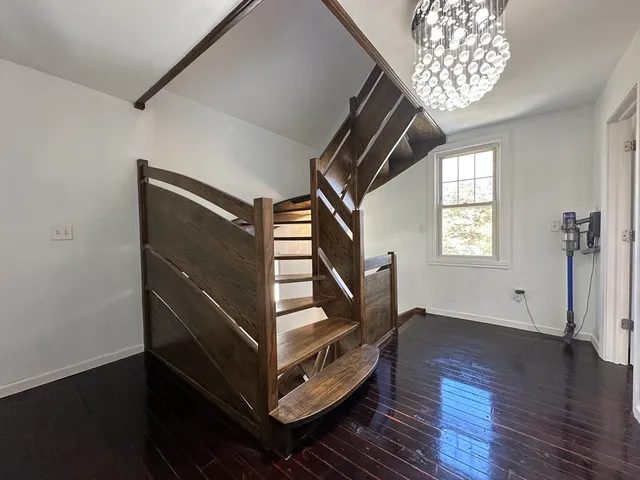 a view of entryway with stairs and wooden floor