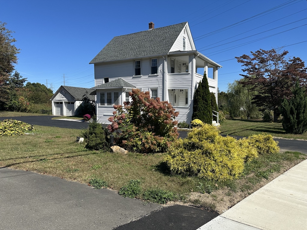 712 Cooper Street Agawam, MA 01001 - Photo 2 of 26 a front view of a house with a yard